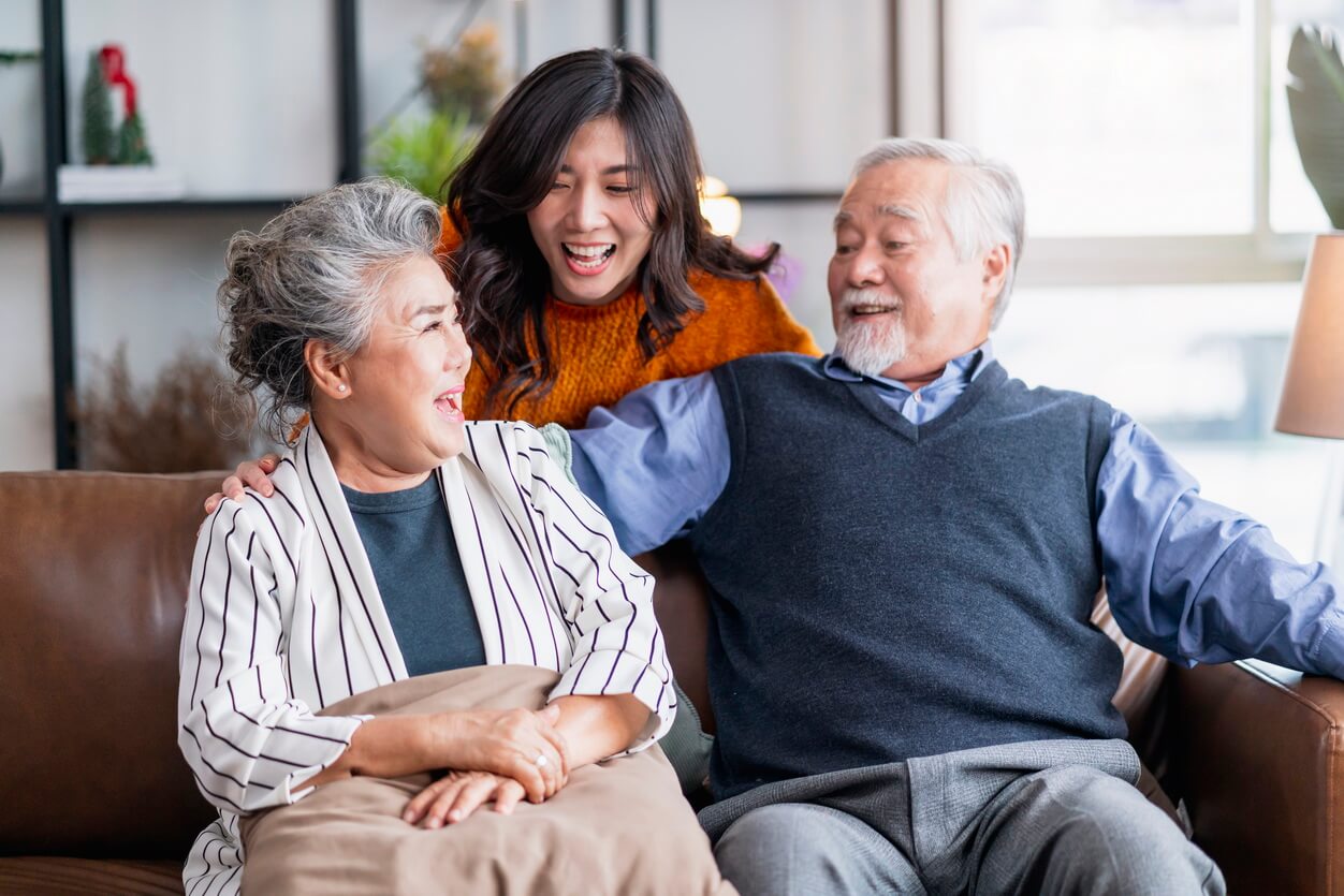 happiness-asian-family-candid-daughter-hug-grandparent-mother-farther-senior-elder-cozy-relax-sofa-couch-surprise-visiting-living-room-hometogether-hug-cheerful-asian-family-home (1)